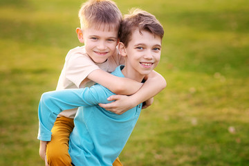 Fototapeta premium Happy children play and relax in the summer park.