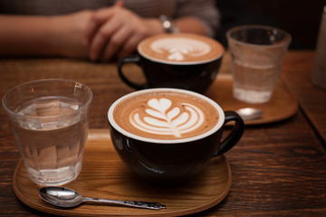 Two Mocha coffees with water served at a cafe