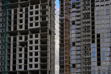 Fototapeta na wymiar Construction site. High rise Building under construction. Construction of high-rise residential building