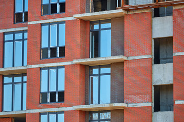 Fototapeta premium Construction site. High rise Building under construction. Construction of high-rise residential building
