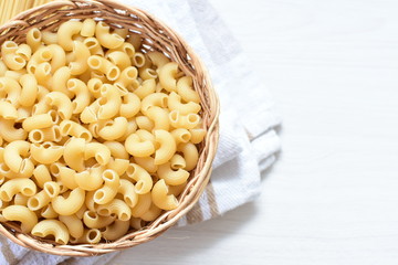 Italian long and short pasta, on white wooden background
