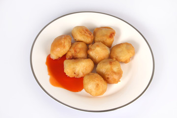 Chinese Cuisine, sweet and sour chicken balls against a white background