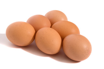 A studio photograph of half a dozen hen's eggs