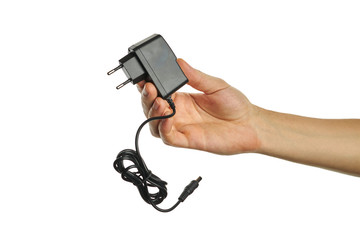 dc power adapter at caucasian persons hand. isolated on a white background. charger tool.