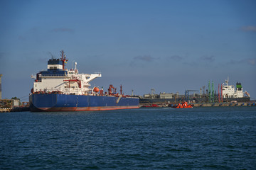 Oil tanker at the port terminal. Tanker in port at oil terminal