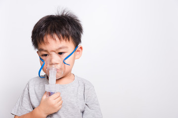 Closeup Asian face, Little children boy sick he using steam inhaler nebulizer mask inhalation...