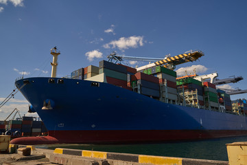 Container ship in port at container terminal. Ships of container ships stand in terminal of port on...