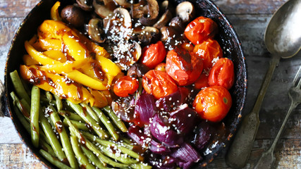 Fototapeta na wymiar Selective focus. Frying pan with baked vegetables. Vegan diet.