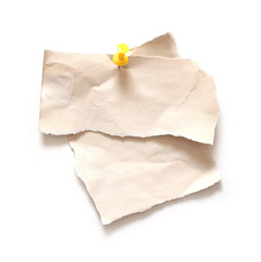 close up of old torn paper with push pin on white paper background