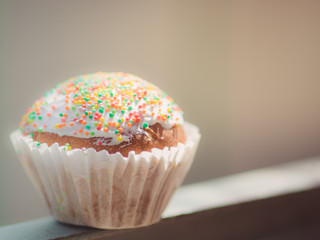 small easter cupcake wrapped in white paper.