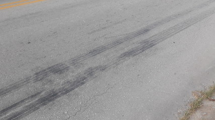 brand of tire brake on asphalt road texture background