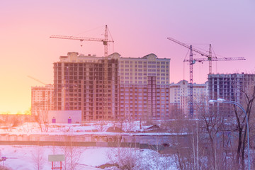 winter morning, the construction of multi-storey residential buildings on the outskirts of the city