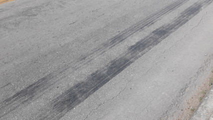 brand of tire brake on asphalt road texture background