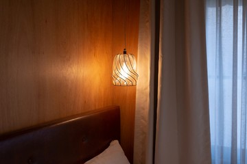 The ceiling lighting is hanging from the ceiling on the bed. Shallow depth of field.