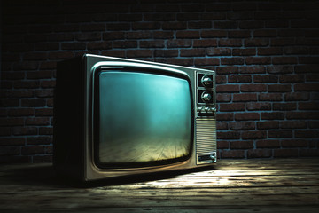 Vintage old TV still life on wooden floor with brick wall in dark room
