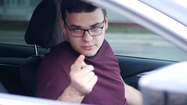 Young man angry in car