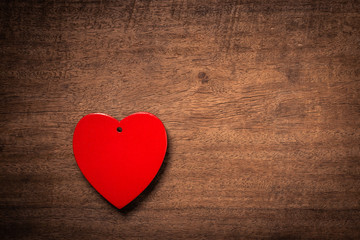 Red heart on wooden floor