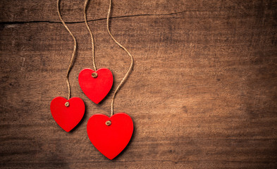 Red hearts on hardwood background