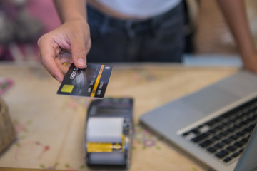 Close up Hand Swiping Credit Card In Store 