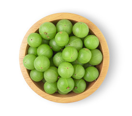 Indian gooseberry in a separate wooden bowl on a white background, top view
