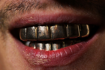 Teeth. Mans gold smile. Perfect gold teeth. Golden teeth grillz.
