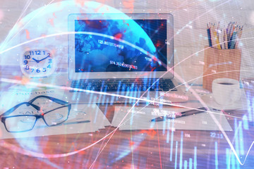 Financial graph colorful drawing and table with computer on background. Double exposure. Concept of international markets.