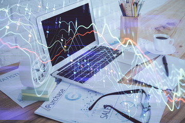 Forex market graph hologram and personal computer on background. Double exposure. Concept of investment.