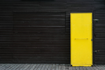 Yellow door in wood wall