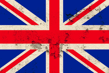 Fototapeta premium national flag of the modern state of Great Britain on an old historical wall with cracks, concept of tourism, travel, emigration, global business