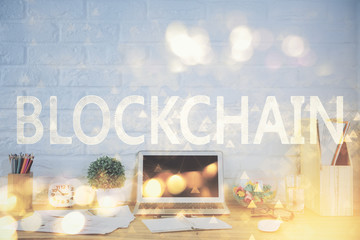 Multi exposure of blockchain and crypto economy theme hologram and table with computer background. Concept of bitcoin cryptocurrency.