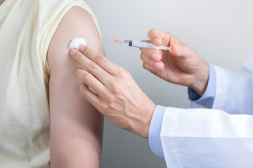 Asian man get coronavirus, flu and measles vaccine shot, vaccination in hospital for good heath,...