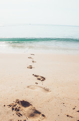 Holiday symbol of quiet rest in attractive areas on the beach, with visible footprints in the sand. Concept for travel vacation - footsteps in sand on summer tropical getaway holidays vacation