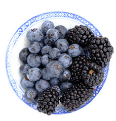 Blueberry and Blackberry on blown cup with white background, fruit concept