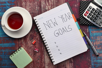 new year goals on notepad on table, top view 