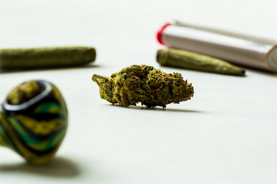 A marijuana bud and a blunt. Smoking marijuana flowers.