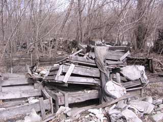 old dirty broken wooden boxes in the trash waste pollute the landfill