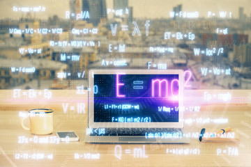 Desktop computer background and formula hologram writing. Double exposure. Education concept.