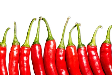 Fotobehang Red chili peppers isolated on white. Hot spicy food ingredient. Empty copy space vegetable background. © Paweł Michałowski