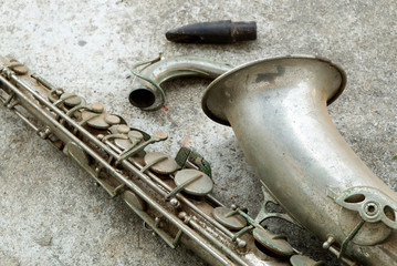 Beautiful Old and Antique Aged Tenor Saxophone on the Concrete Floor. 