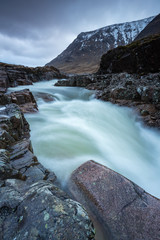 the river coupall waterfalls on rannoch moor showing buachaille etive mor in the background as the entrance to glencoe valley in winter