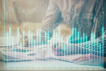 Multi exposure of forex chart with man working on computer on background. Concept of market...