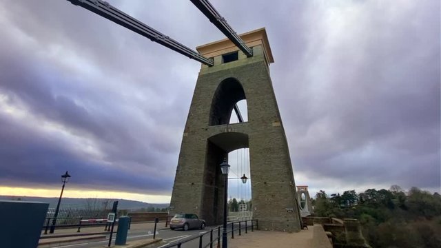 Looking up at the imposing tower of the Clifton Suspension Bridge, in Bristol, under the heavy skies of the approaching Storm Brendan