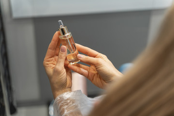 Close up of female hands that holding glass package