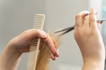 Close up of female hands that cutting hair