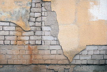 ruined brick wall with stucco and rust