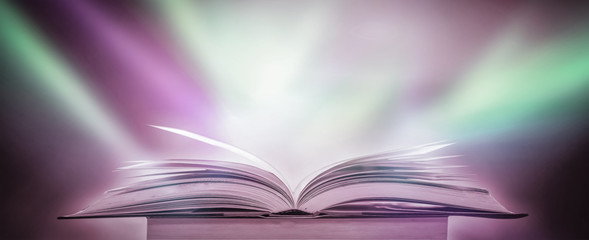 The blurred book that is bewitched with magic, the magic light in the dark, with the bright light shining down as the power to search for knowledge. For research and use as a blurred background