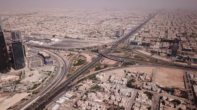Aerial view of busy intersection in Riyadh, traffic driving through capital city of Saudi Arabia