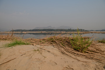 Lamtakong lake shore with boats and fishing traps at sunset, Lam Takong dam, Nakornratchima, Thailand