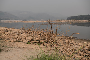 Lamtakong lake shore with boats and fishing traps at sunset, Lam Takong dam, Nakornratchima, Thailand