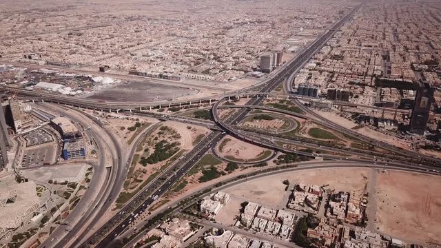 Tilting drone shot of busy highway junction in Riyadh (near new financial district), transportation and infrastructure in Saudi Arabia